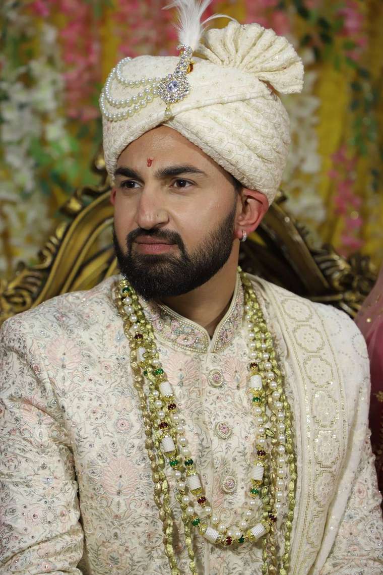 Groom in ivory sherwani and safa